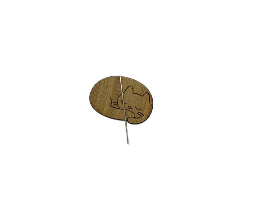 Cat-shaped needle minder with a strong magnet to hold needles, perfect for embroidery and cross-stitch projects.