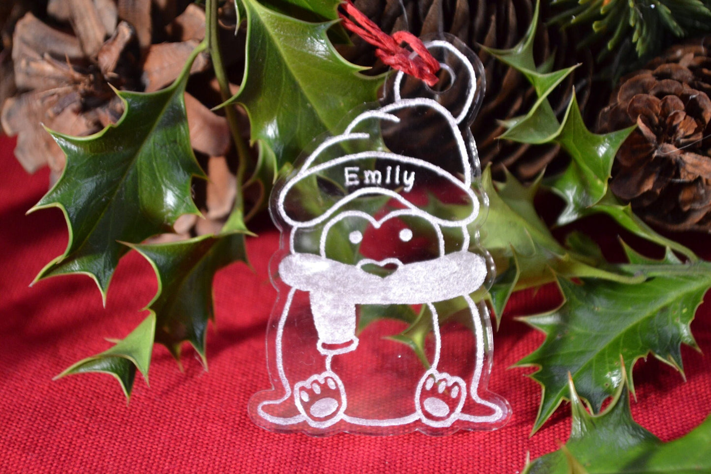 Clear acrylic penguin design engraved with any name on the Santa hat for a personalised Christmas tree bauble.