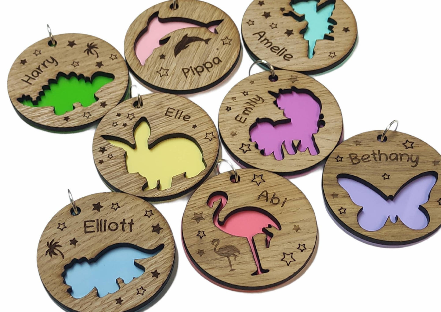 Circular keyring with a cut-out bunny rabbit design backed with colourful acrylic, laser engraved with a personalised name on oak veneer.