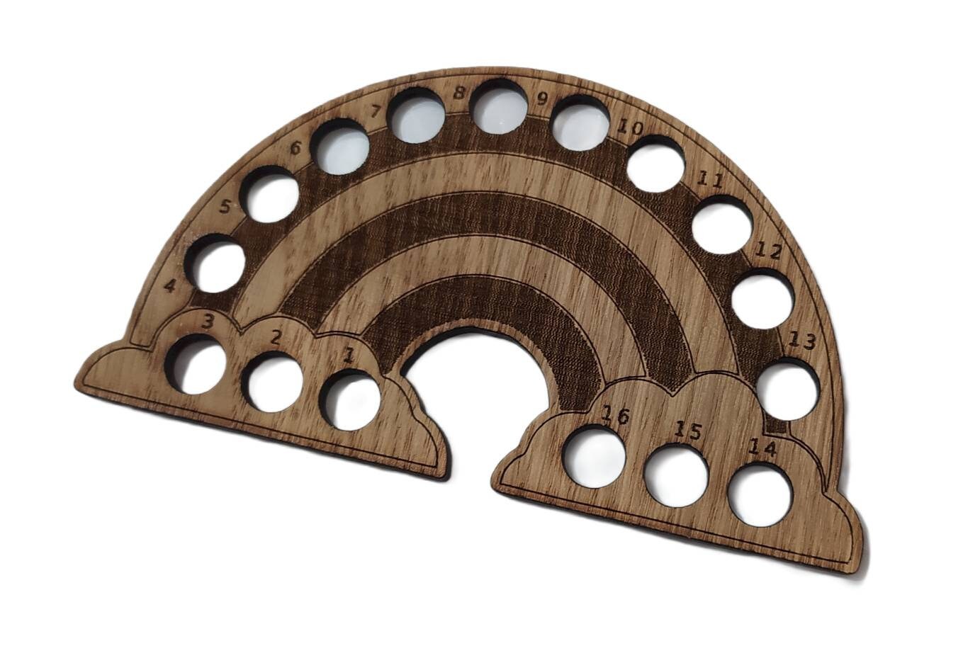 Rainbow-shaped thread holder with 16 holes for organising thread.
