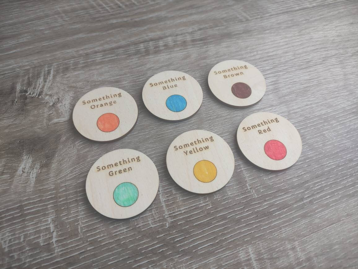 Wooden discs with engraved scavenger hunt prompts, featuring different things to find.