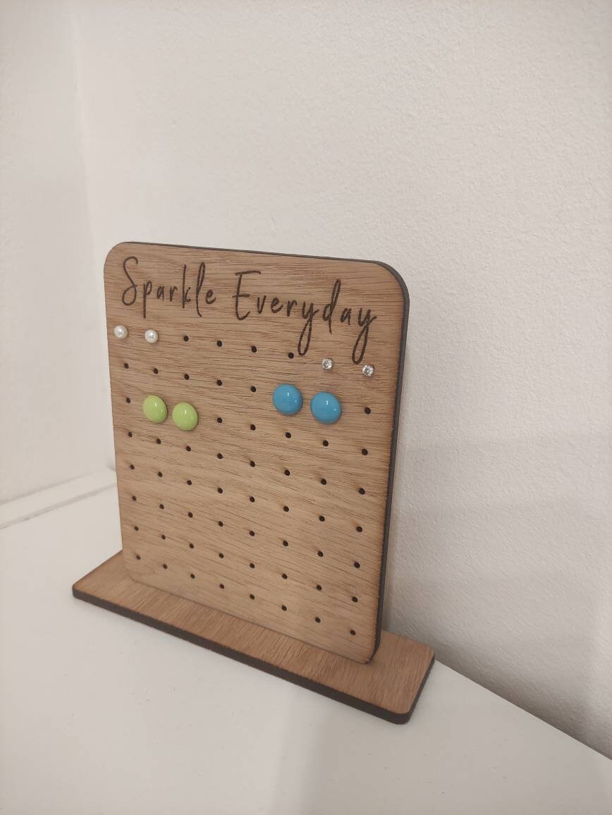 Laser-engraved oak veneer earring holder with the message "Sparkle Everyday," designed to hold up to 32 pairs of stud earrings.