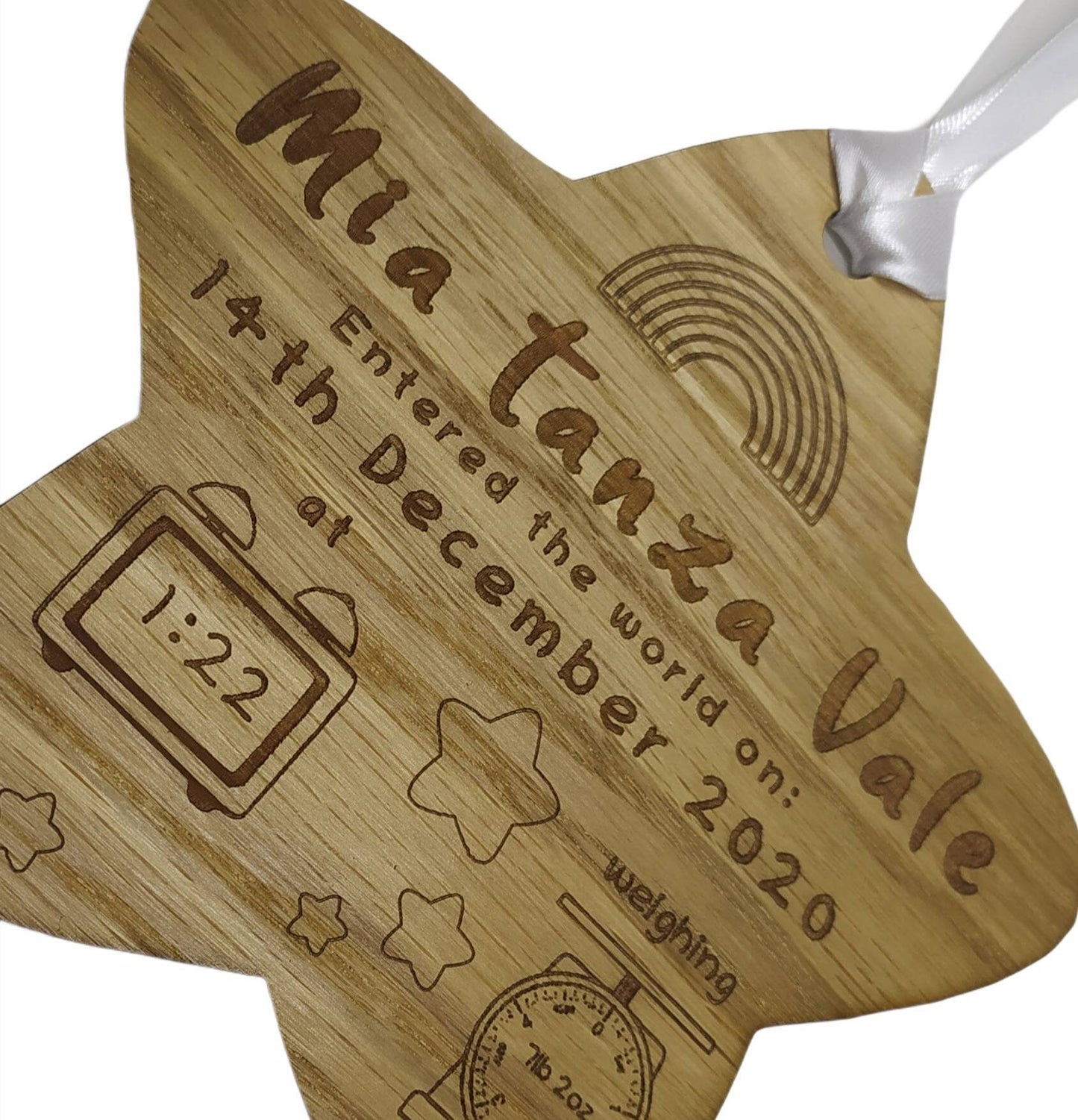 Personalised oak veneer wooden star engraved with a newborn's full name, date of birth, time, and weight. Finished with a white string for hanging, making it a thoughtful keepsake for families.