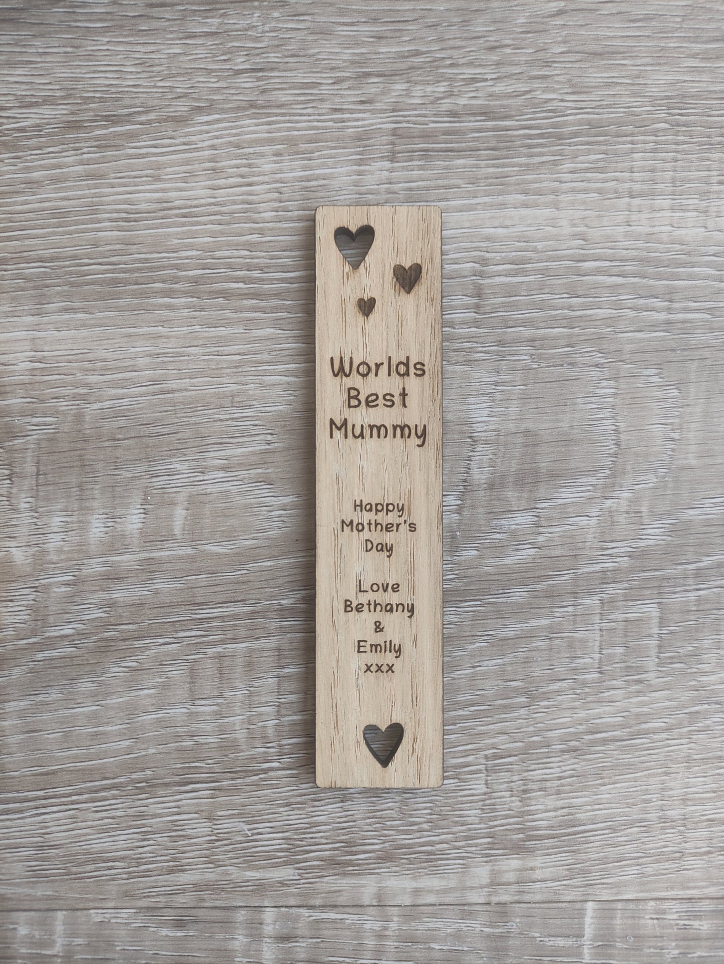 Wooden bookmark featuring cut-out heart shapes and custom engraving, personalised with any wording.