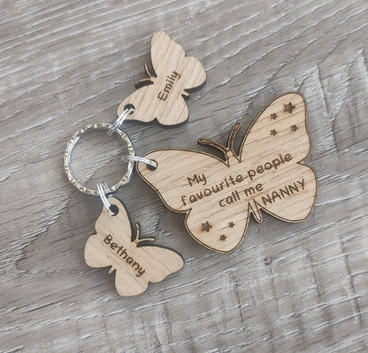 Butterfly design keyring engraved with "My favourite people call me NANNY" and custom butterfly-shaped charms.