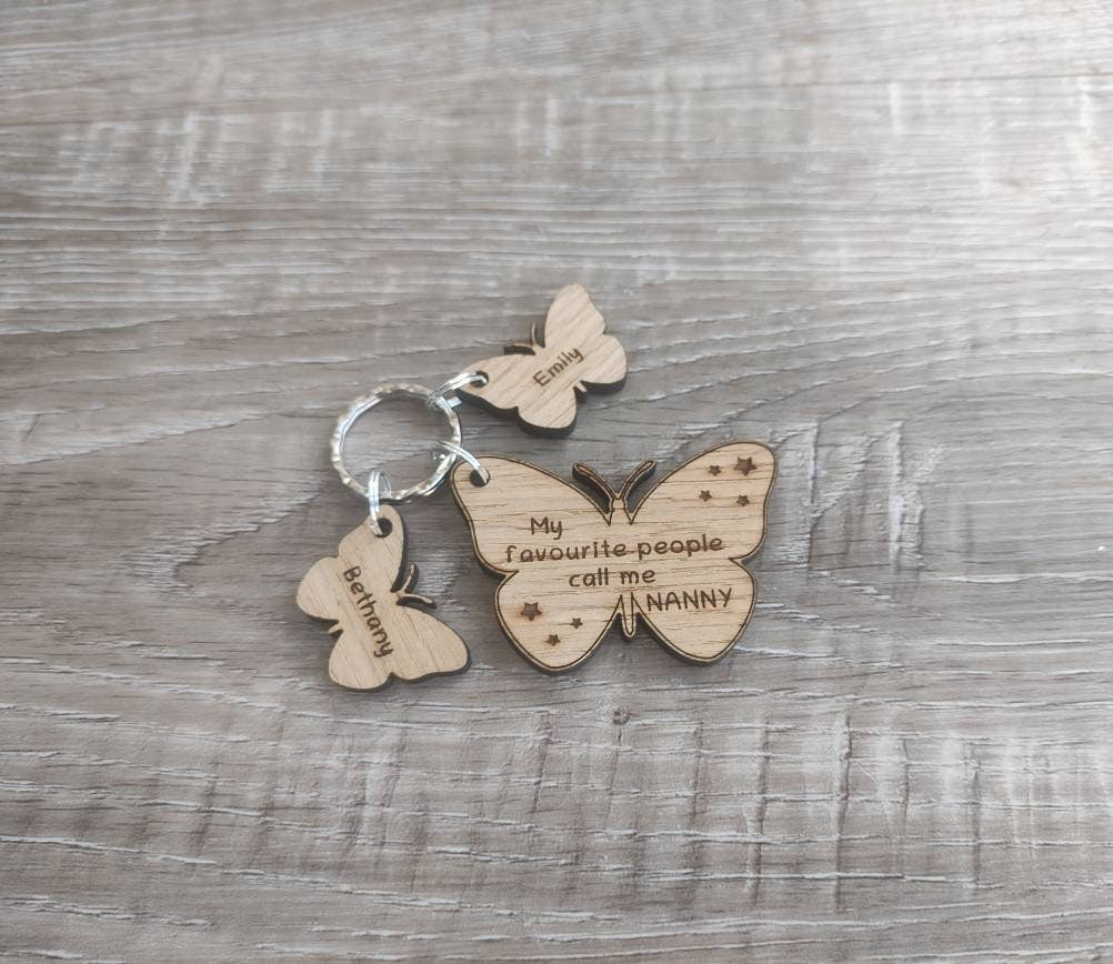 Butterfly design keyring engraved with "My favourite people call me NANNY" and custom butterfly-shaped charms.