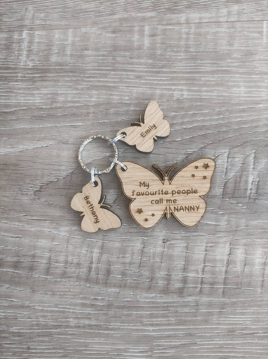 Butterfly design keyring engraved with "My favourite people call me NANNY" and custom butterfly-shaped charms.