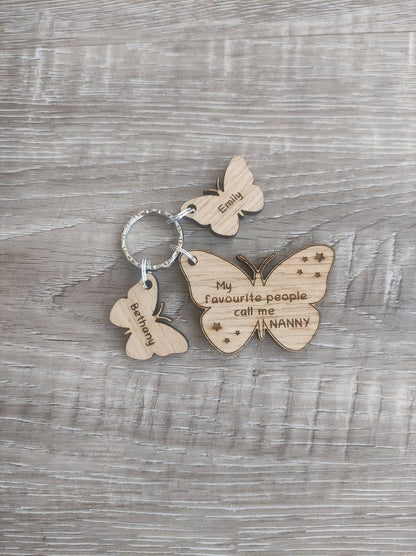 Butterfly design keyring engraved with "My favourite people call me NANNY" and custom butterfly-shaped charms.