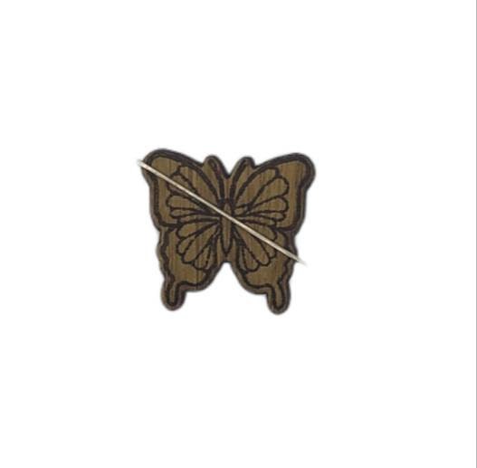 Butterfly shape needle minder on oak veneer wood