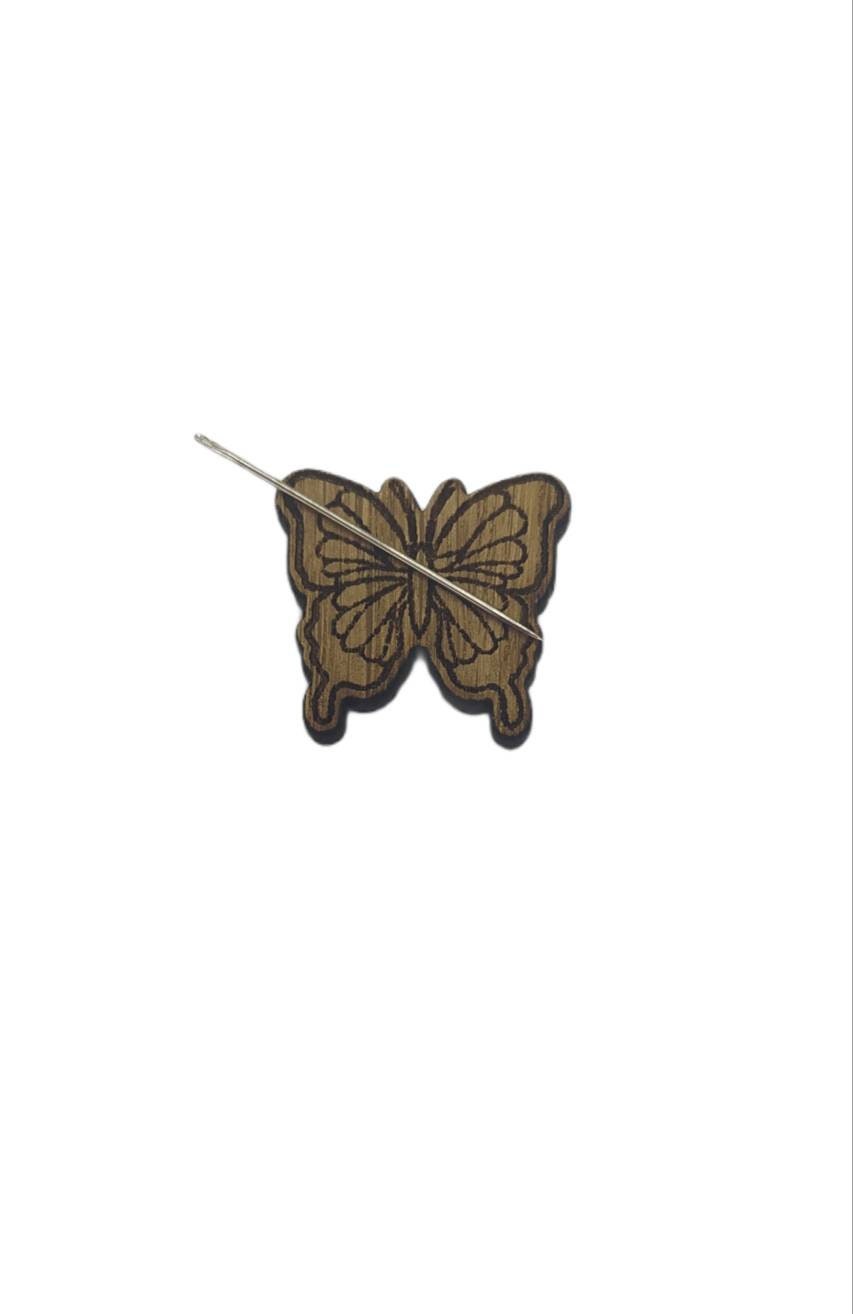 Butterfly shape needle minder on oak veneer wood