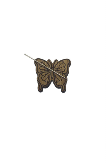 Butterfly shape needle minder on oak veneer wood