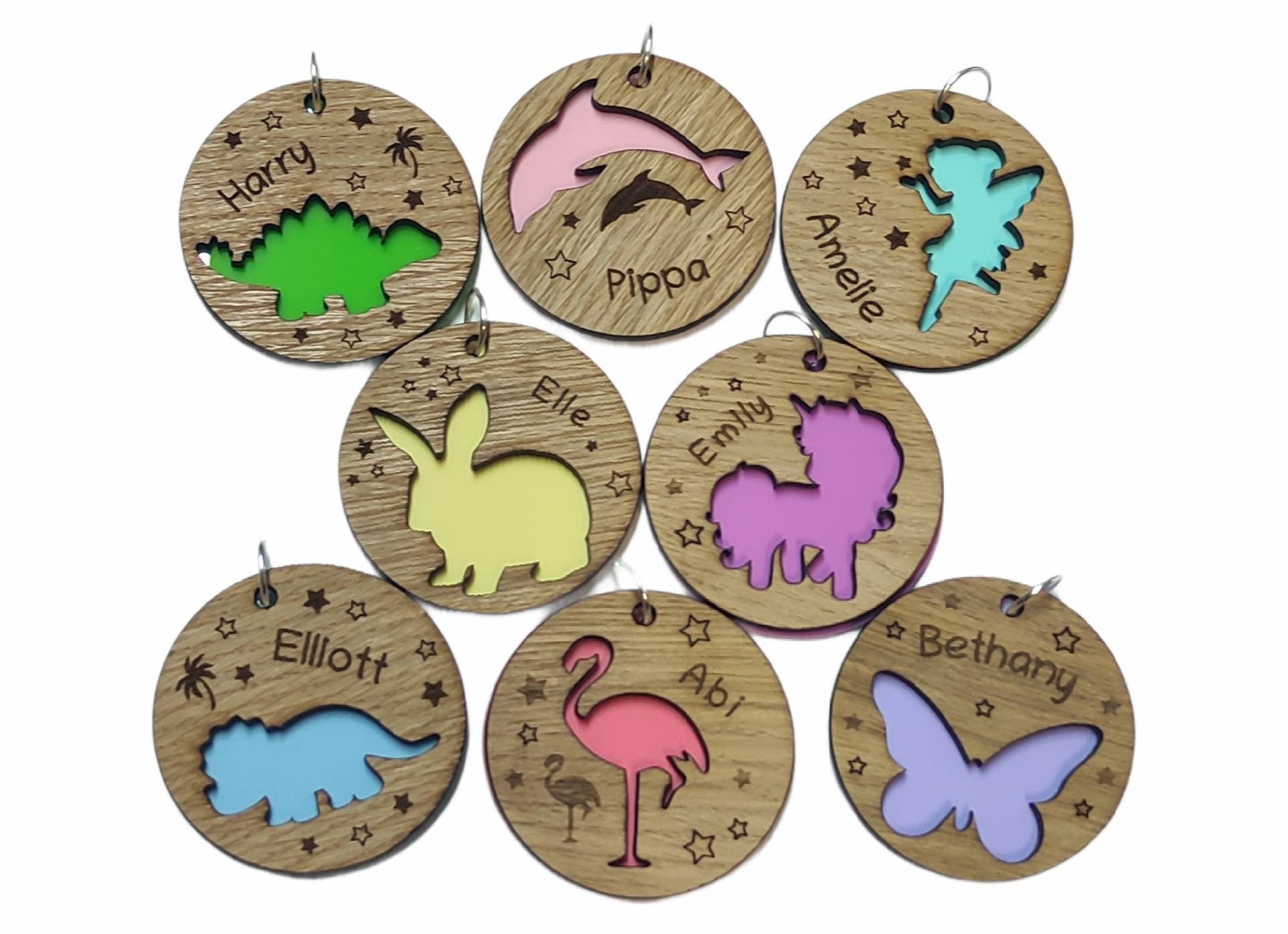 Circular keyring featuring a cut-out butterfly design backed with colourful acrylic, laser engraved with a personalised name on oak veneer.