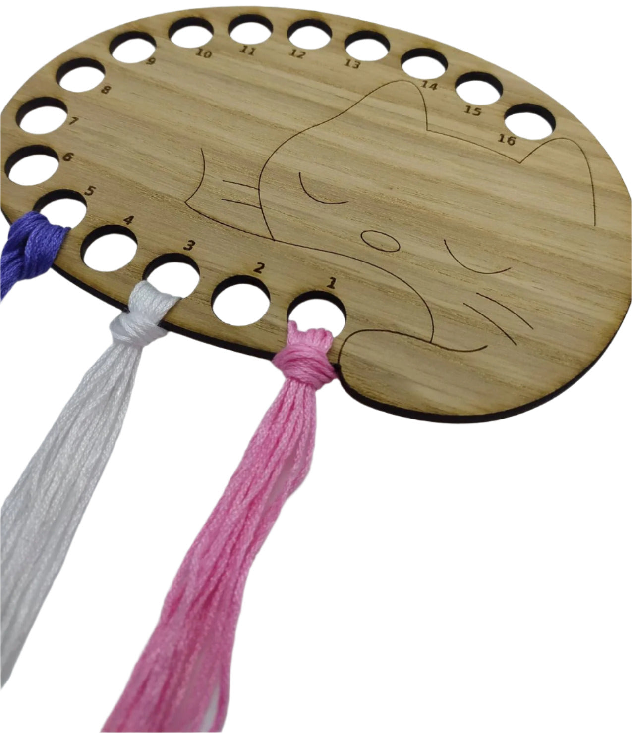 Cat thread holder in a sleeping cat design with 16 holes for thread.