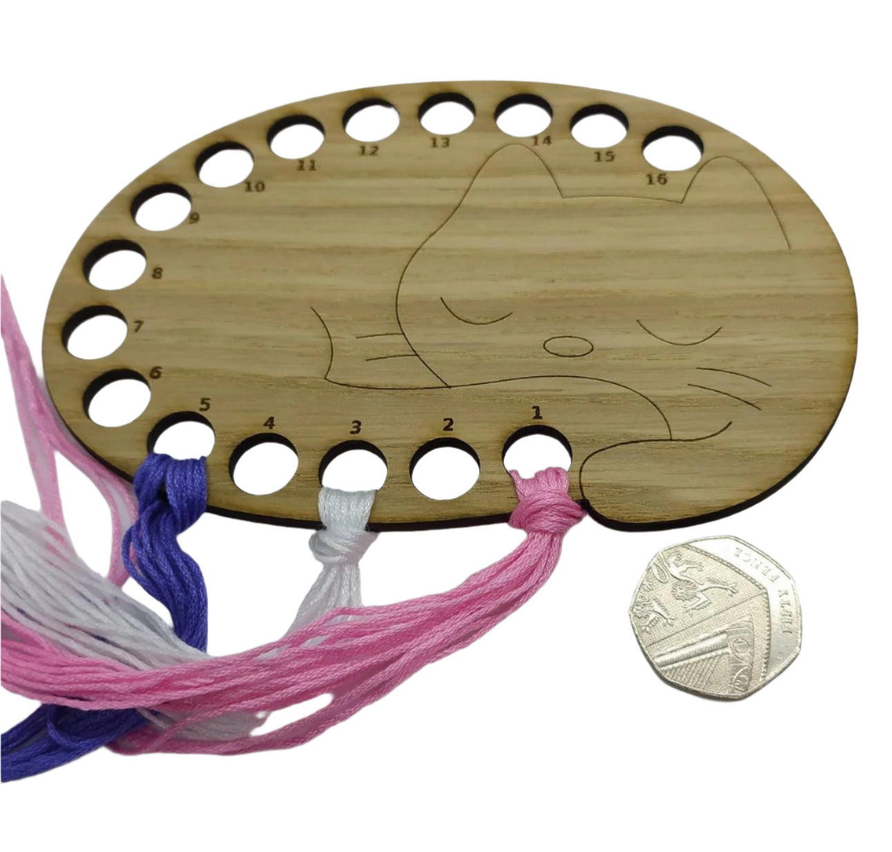 Cat thread holder in a sleeping cat design with 16 holes for thread.