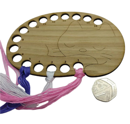 Cat thread holder in a sleeping cat design with 16 holes for thread.