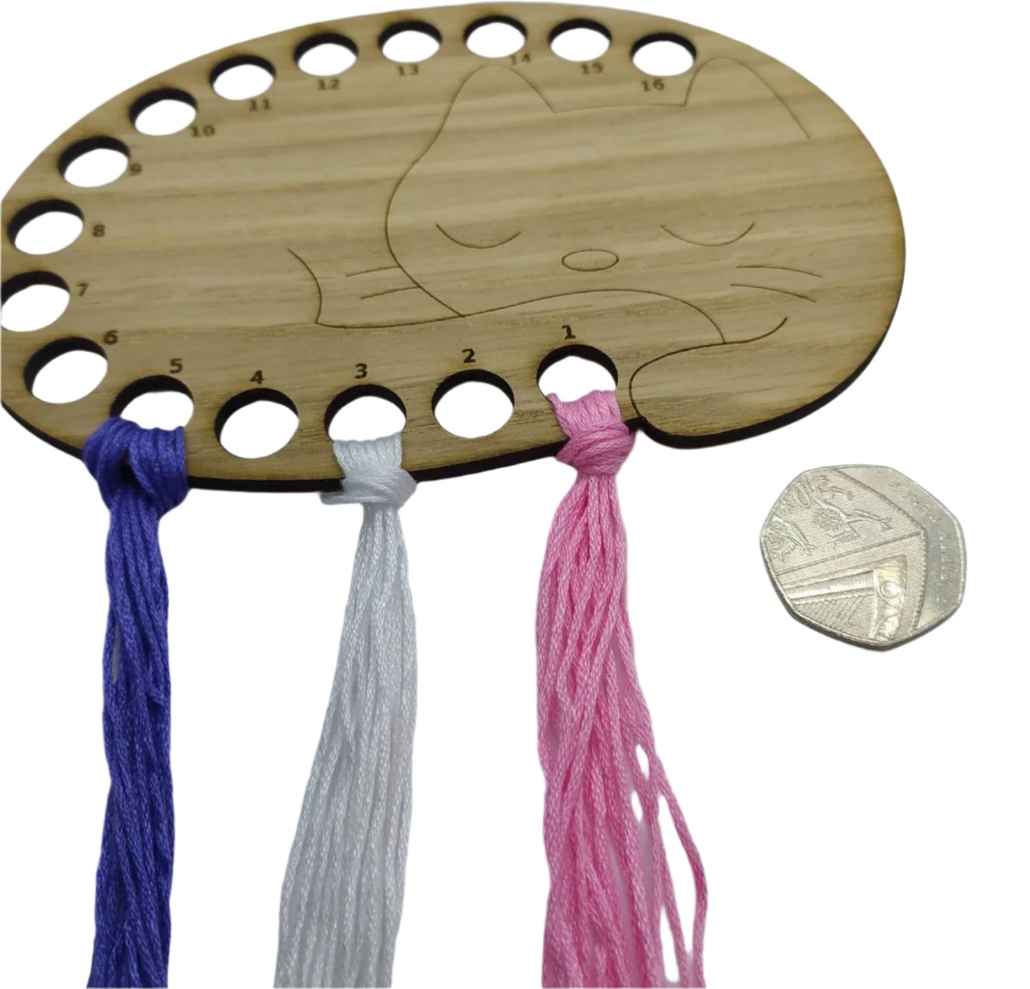 Cat thread holder in a sleeping cat design with 16 holes for thread.