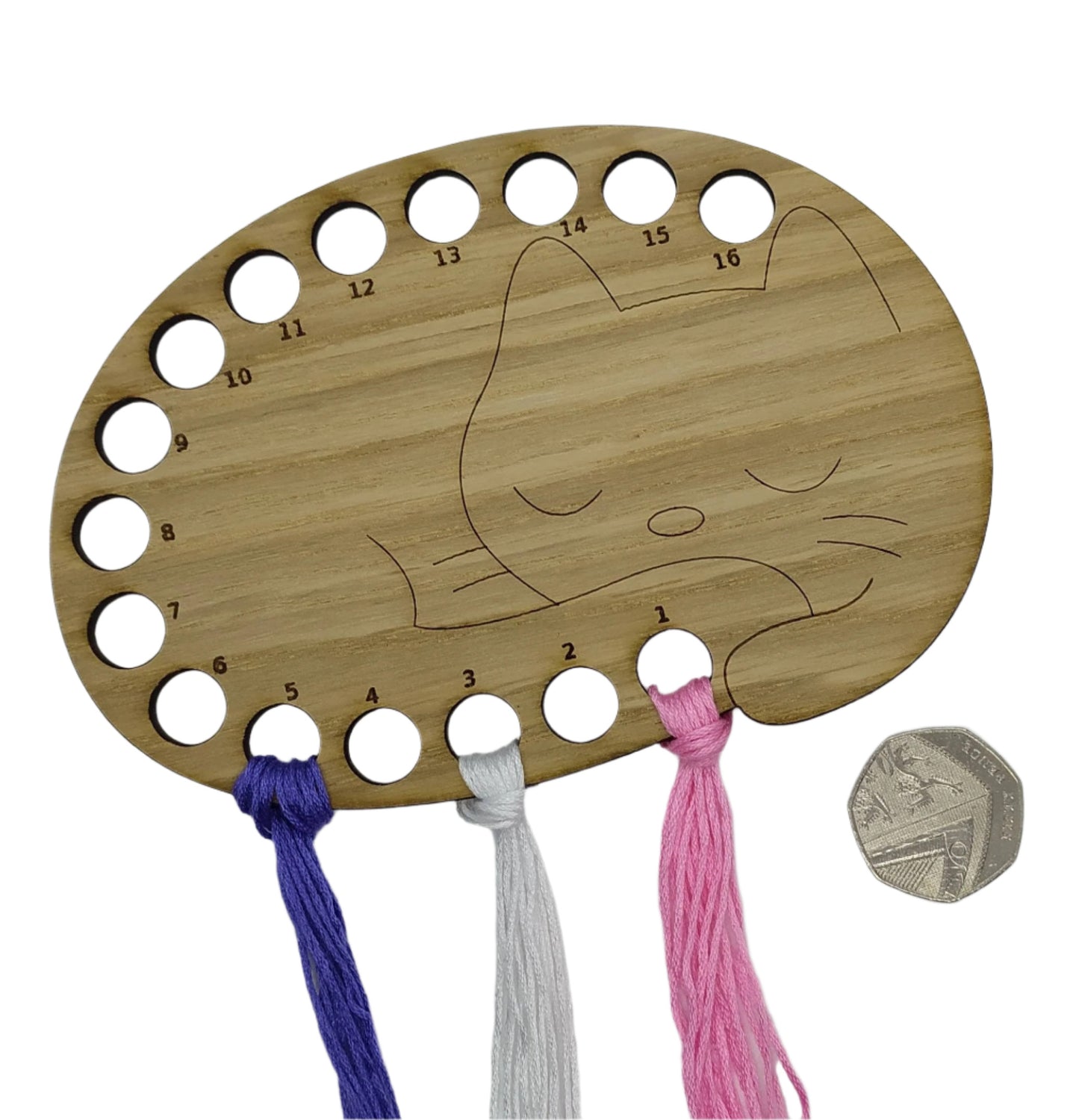 Cat thread holder in a sleeping cat design with 16 holes for thread.