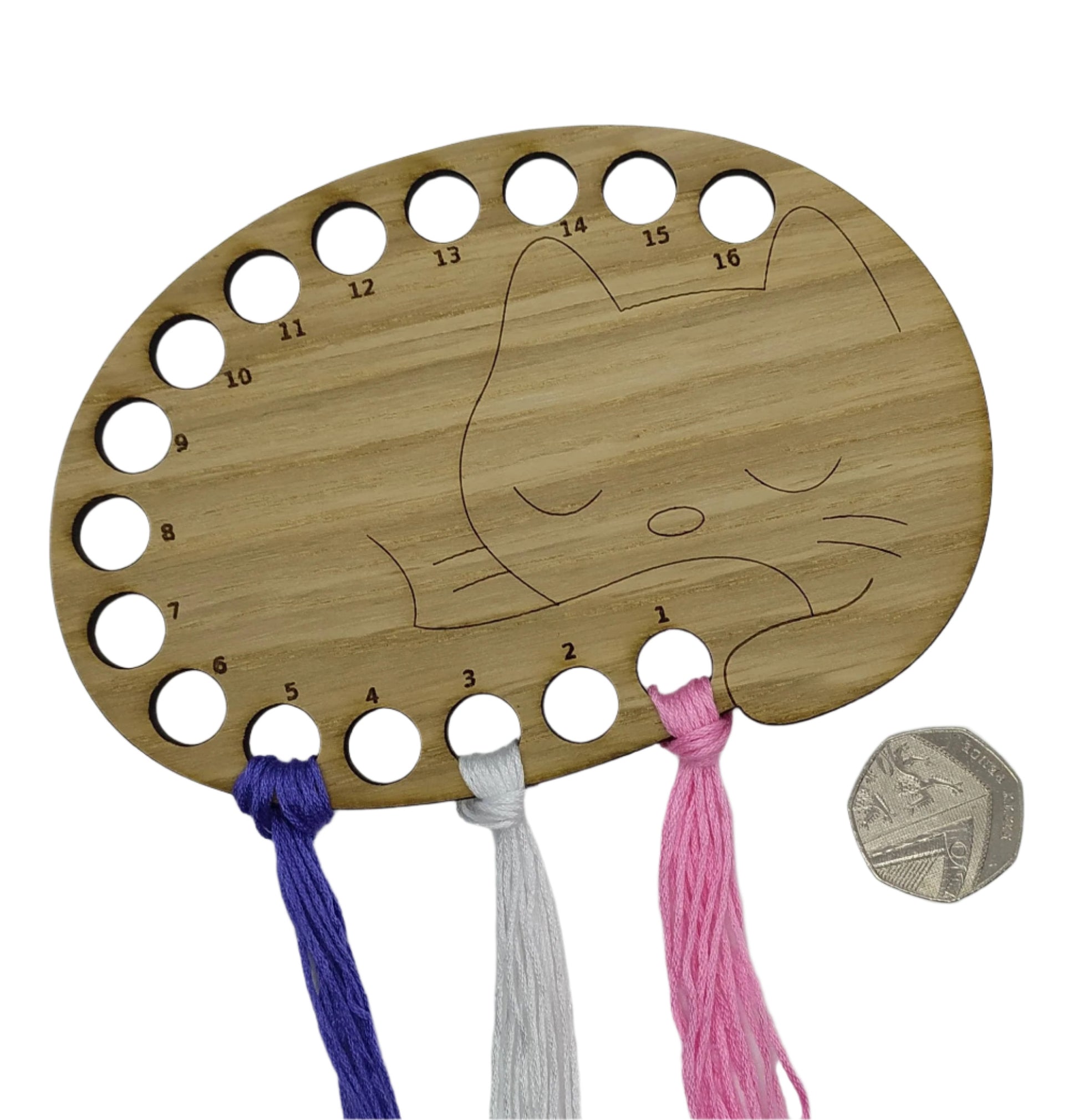 Cat thread holder in a sleeping cat design with 16 holes for thread.