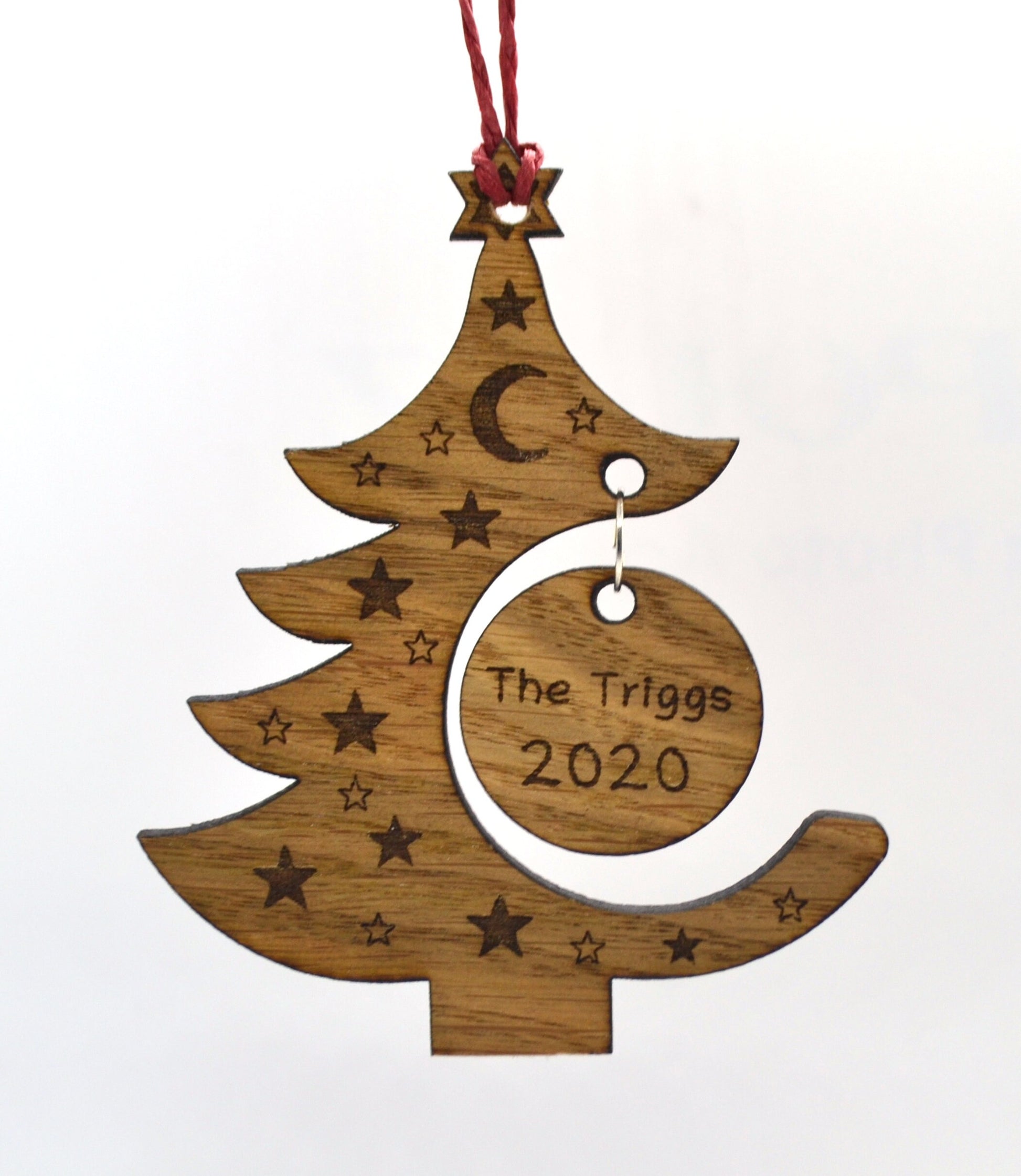 "Personalised Christmas tree bauble with custom name engraved, made from natural wood or clear acrylic."