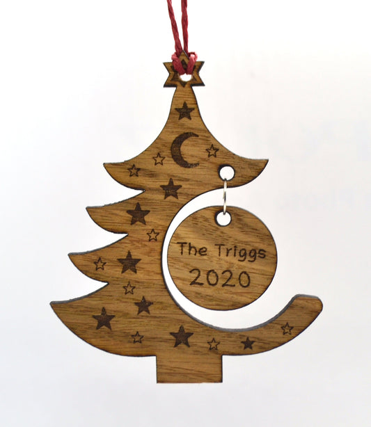"Personalised Christmas tree bauble with custom name engraved, made from natural wood or clear acrylic."