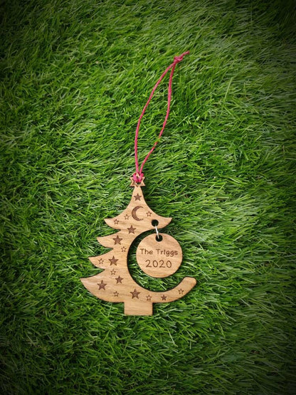 "Personalised Christmas tree bauble with custom name engraved, made from natural wood or clear acrylic."
