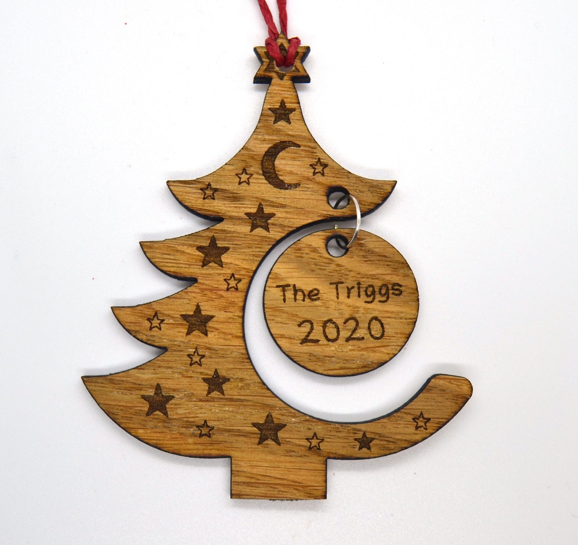 "Personalised Christmas tree bauble with custom name engraved, made from natural wood or clear acrylic."