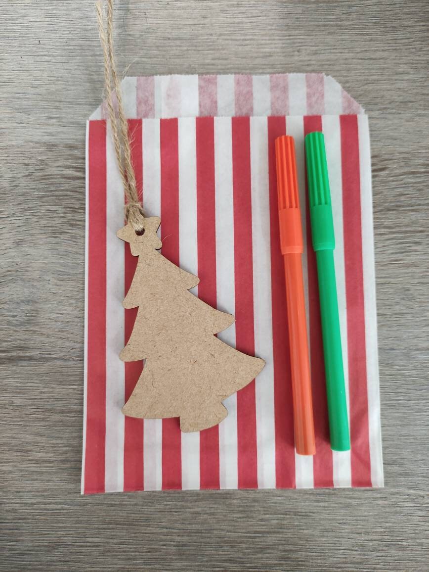 Wooden laser-cut shape with a hole at the top for hanging, string included, and 2 coloured pens inside a paper bag.