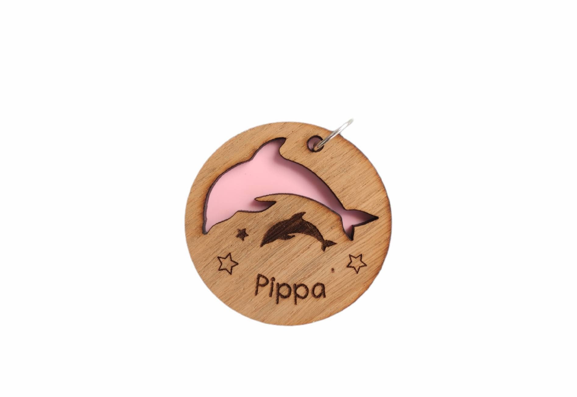 Circle keyring with a cut-out dolphin shape, backed with coloured acrylic, engraved with any name.