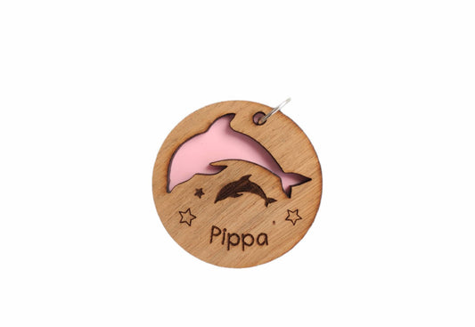 Circle keyring with a cut-out dolphin shape, backed with coloured acrylic, engraved with any name.