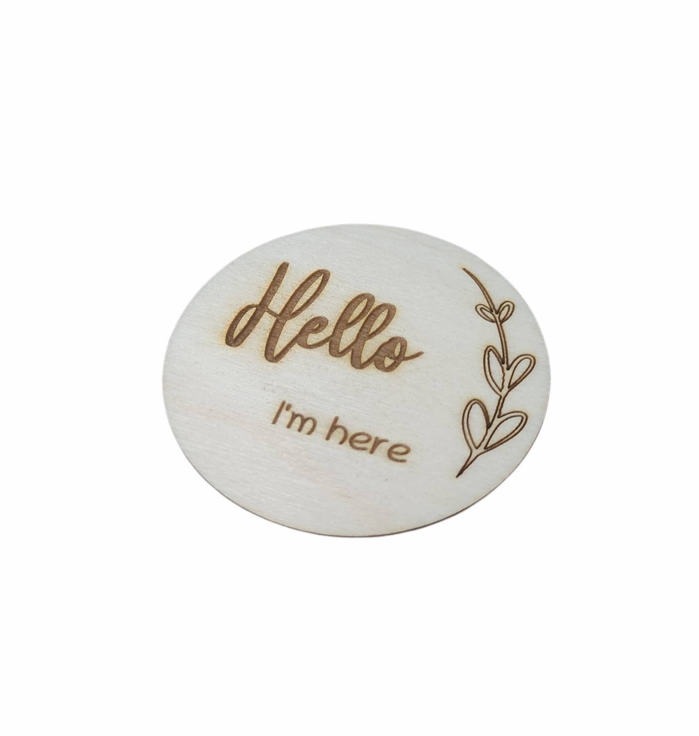 Personalised wooden milestone markers, engraved on 3mm plywood with a natural wood finish. Sized at 70mm x 70mm, they feature designs like 'Hello, I'm here' and other customisable options.