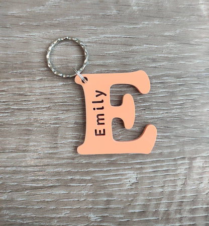 Personalised coloured acrylic keyring with engraved first letter, ideal for key identification and unique gifts.