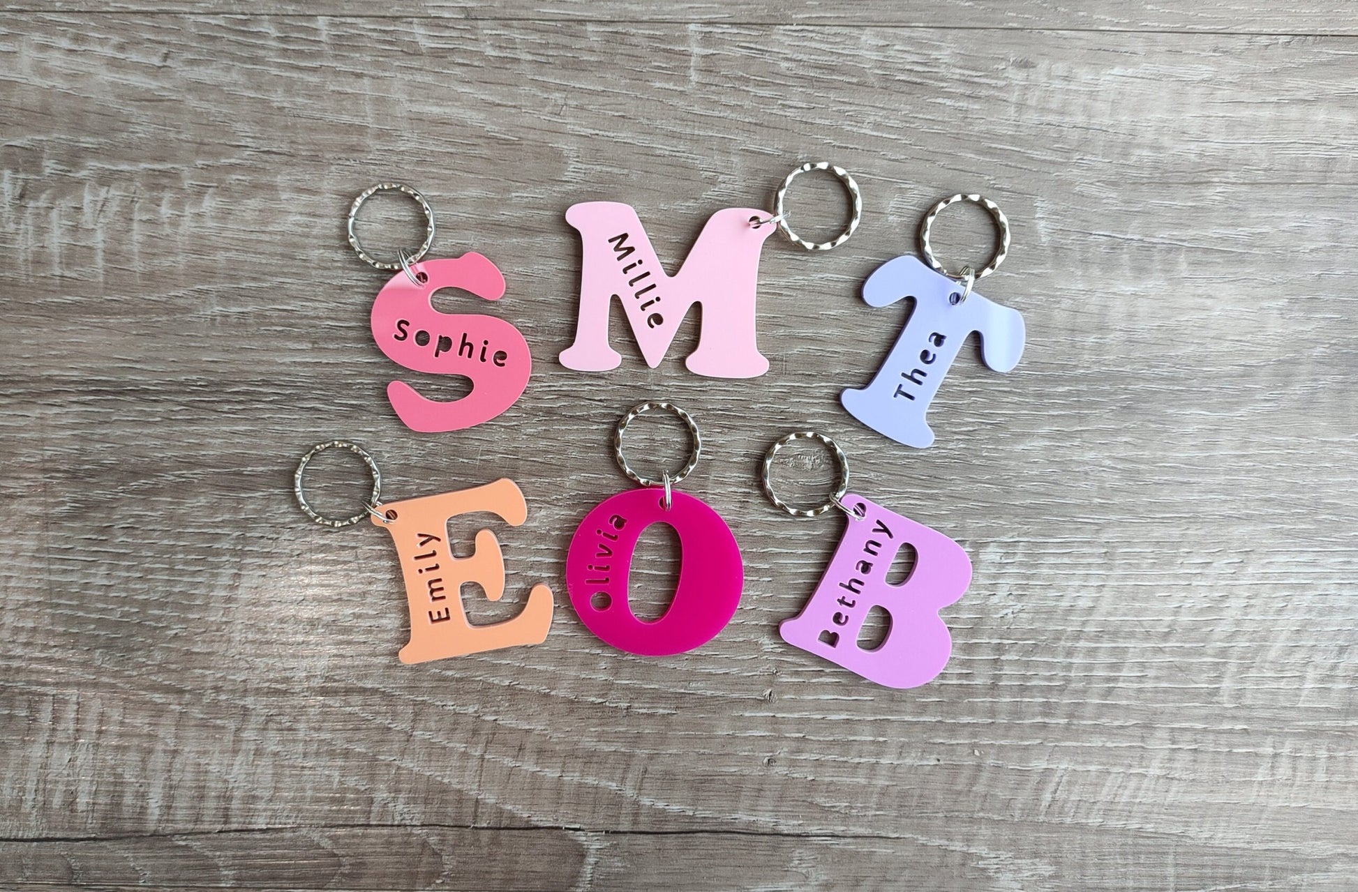 Coloured acrylic keyrings with a name cut out in various fun designs.