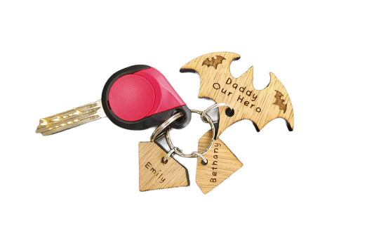 Superhero bat-shaped keyring engraved with "Daddy My Hero" or "Grandad Our Hero," featuring diamond-shaped personalised name charms.