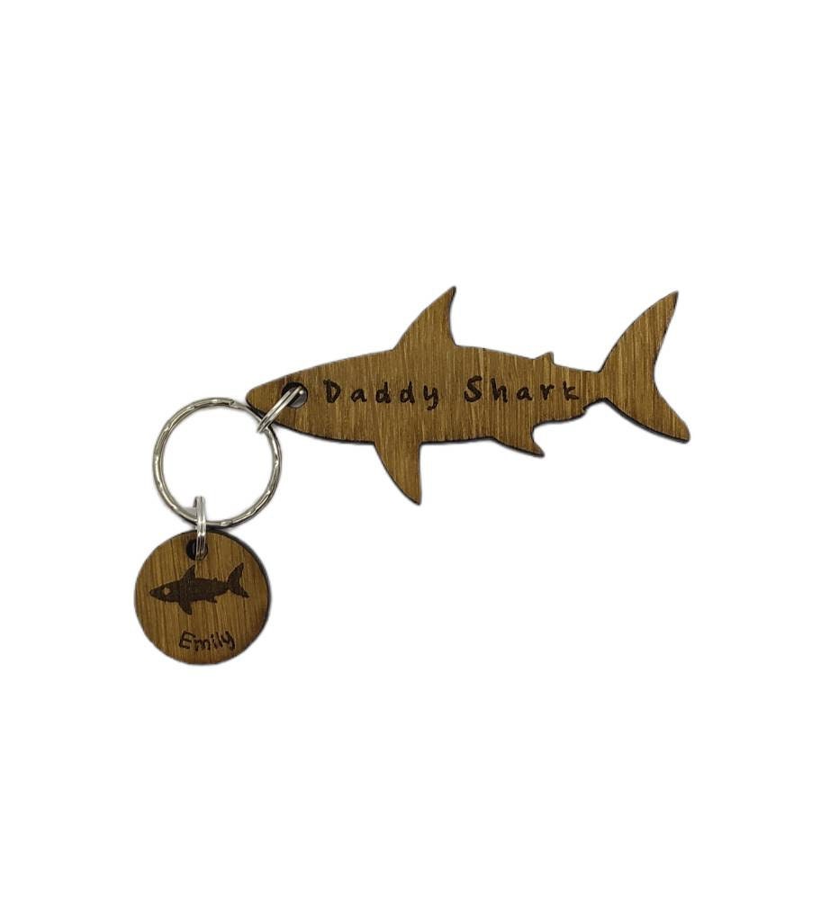 Shark-shaped keyring with "Daddy Shark" engraved in the middle, featuring added circle charms with a name and shark design engraved.