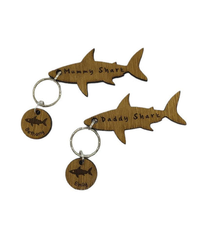 Shark-shaped keyring with "Daddy Shark" engraved in the middle, featuring added circle charms with a name and shark design engraved.