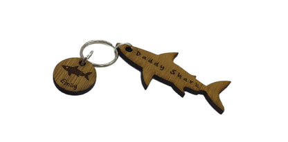 Shark-shaped keyring with "Daddy Shark" engraved in the middle, featuring added circle charms with a name and shark design engraved.