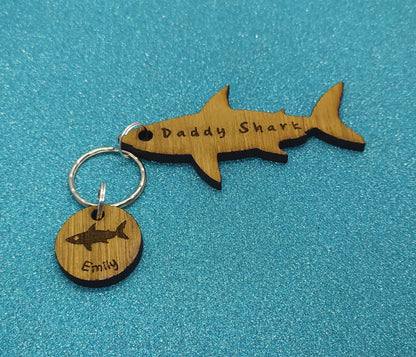 Shark-shaped keyring with "Daddy Shark" engraved in the middle, featuring added circle charms with a name and shark design engraved.