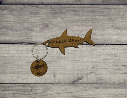 Shark-shaped keyring with "Daddy Shark" engraved in the middle, featuring added circle charms with a name and shark design engraved.