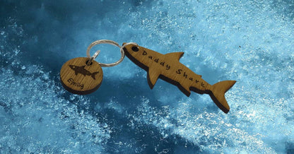 Shark-shaped keyring with "Daddy Shark" engraved in the middle, featuring added circle charms with a name and shark design engraved.