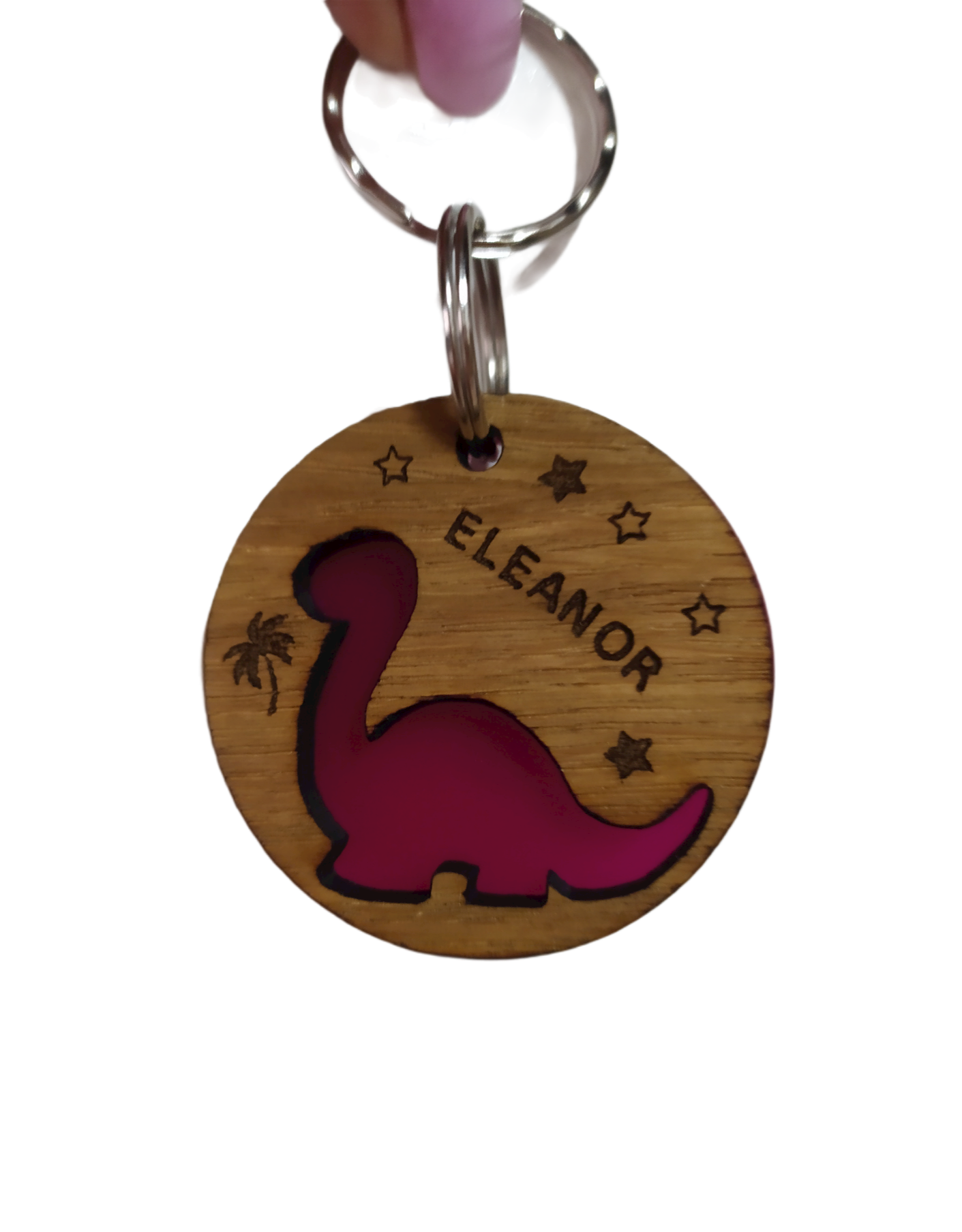 Round keyring with a Diplodocus shape cut out and backed with coloured acrylic, engraved with any name.