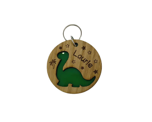 Round keyring with a Diplodocus shape cut out and backed with coloured acrylic, engraved with any name.