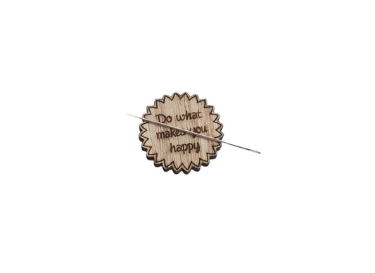 Round soft jagged edges needle minder with "Do What Makes You Happy" engraved: