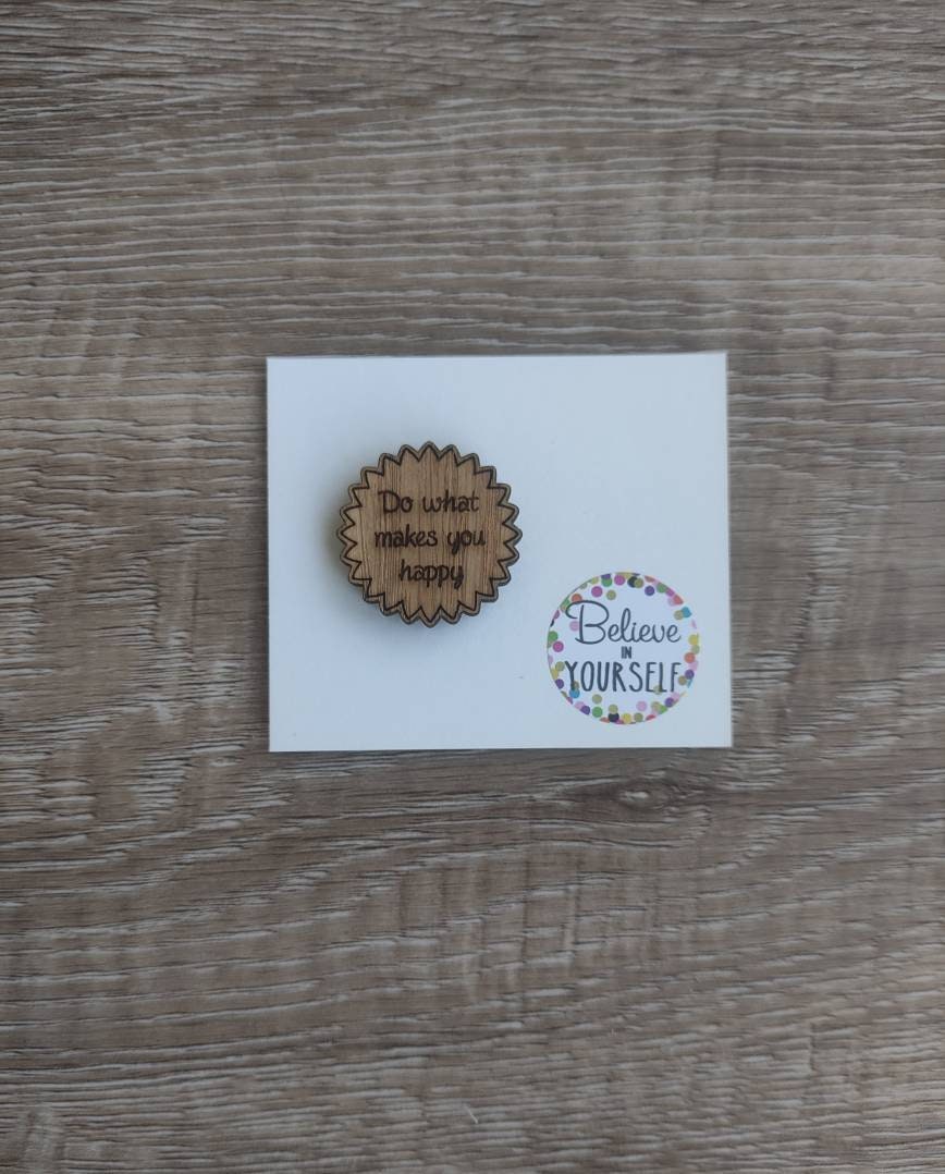 Round soft jagged edges needle minder with "Do What Makes You Happy" engraved: