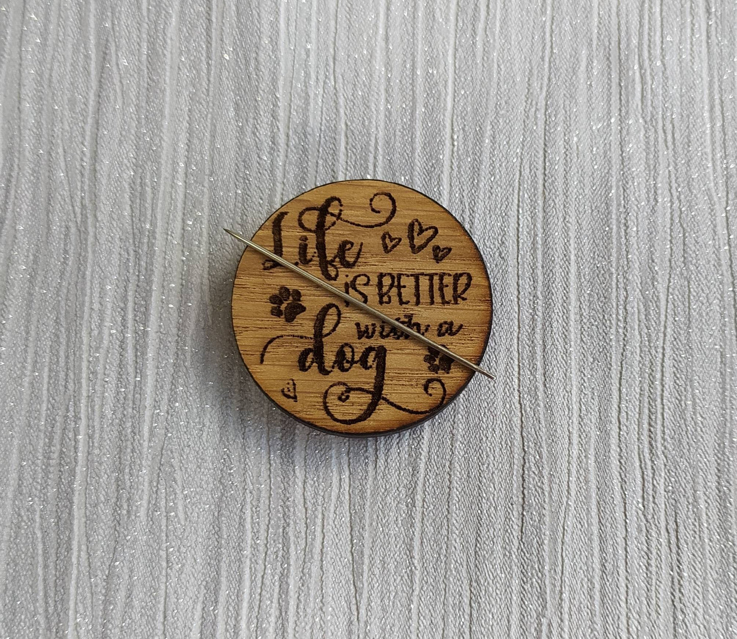 Round needle minder engraved with 'Life is Better with a Dog'
