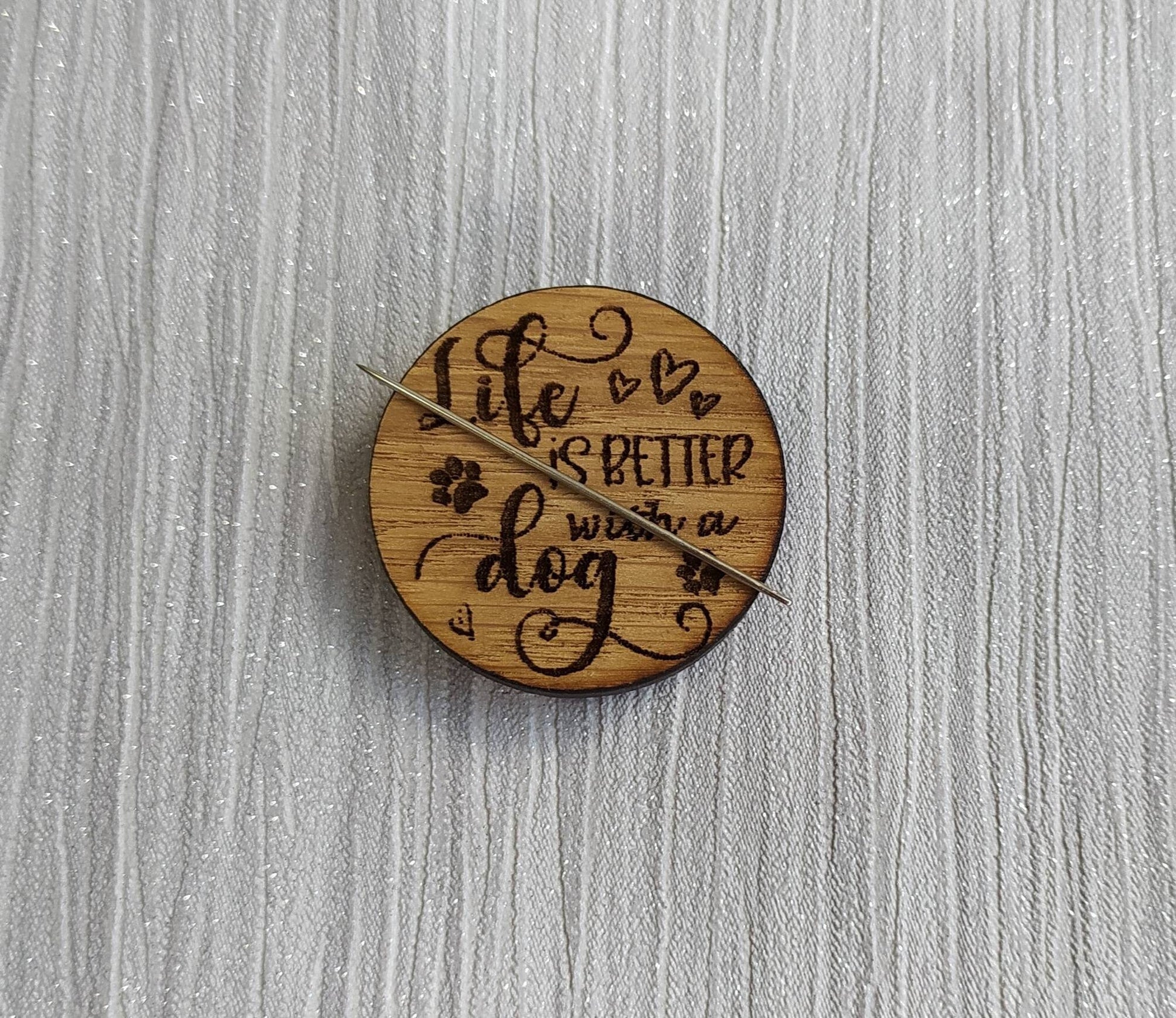 Round needle minder engraved with 'Life is Better with a Dog'
