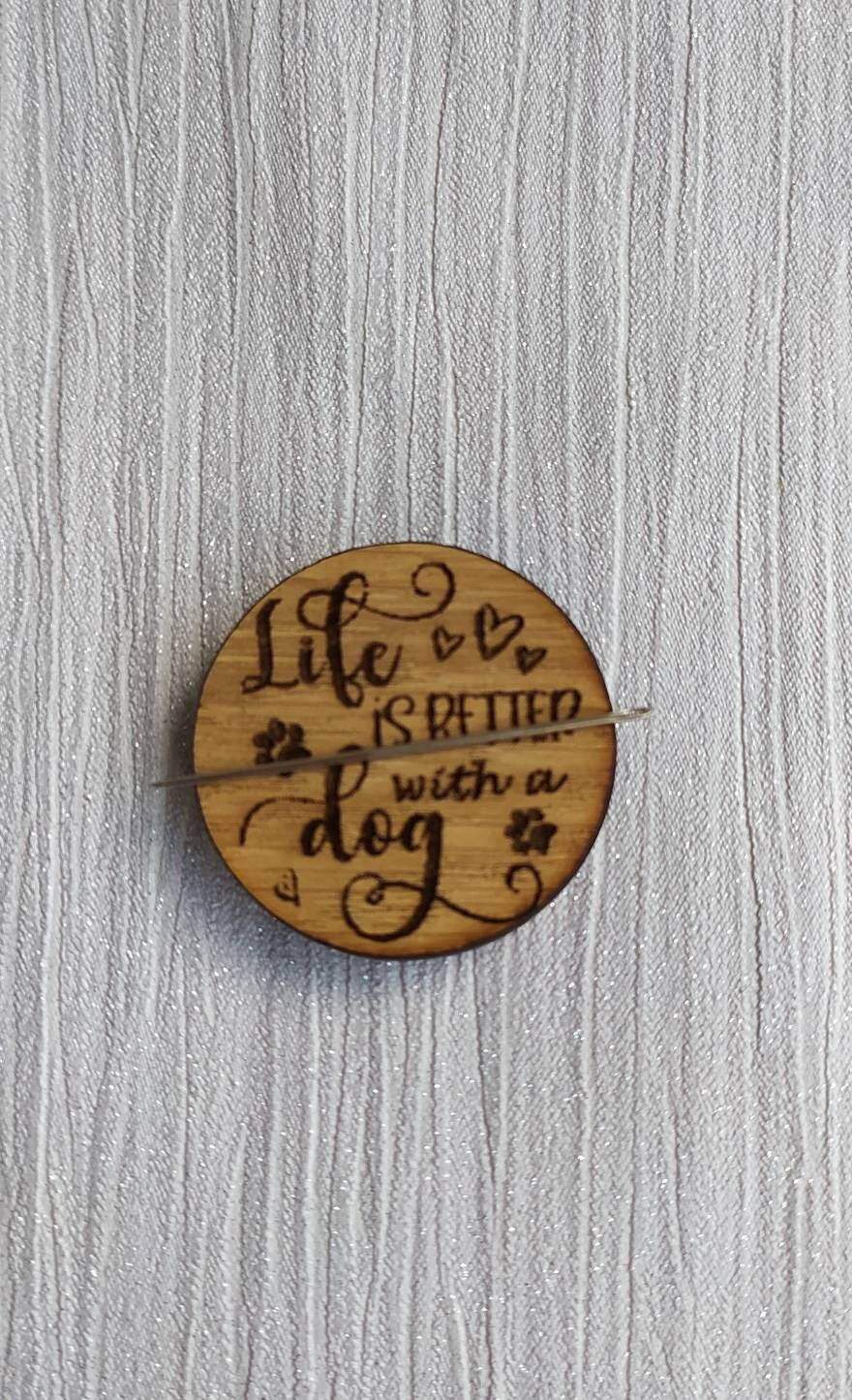 Round needle minder engraved with 'Life is Better with a Dog'
