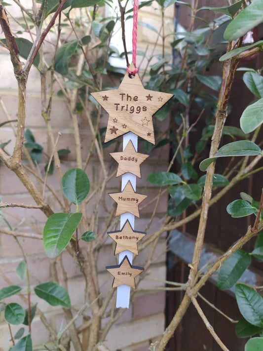 "Personalised Family Christmas Star Tree Hanger with laser-cut stars, custom engraved with family names, featuring red, white, or green hanging string."