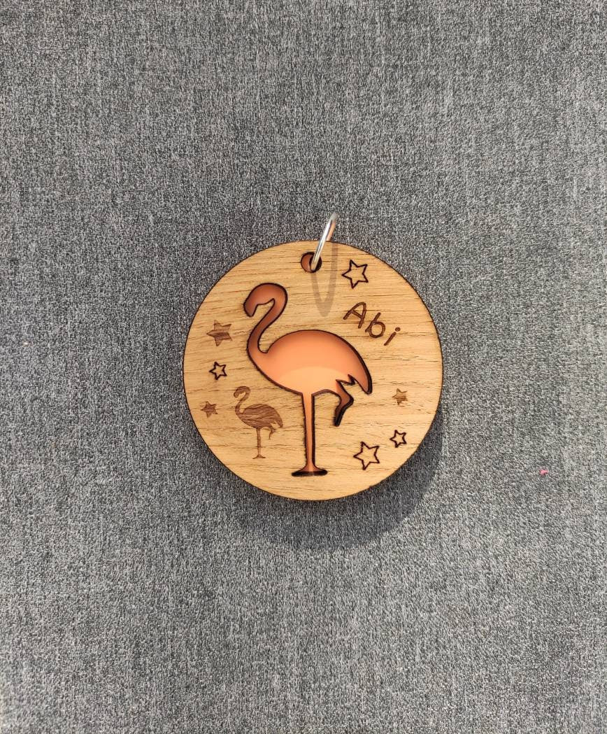 Round wooden keyring with colourful acrylic backing and a laser-cut Flamingo design – personalised with engraved child’s name, perfect for school bags.