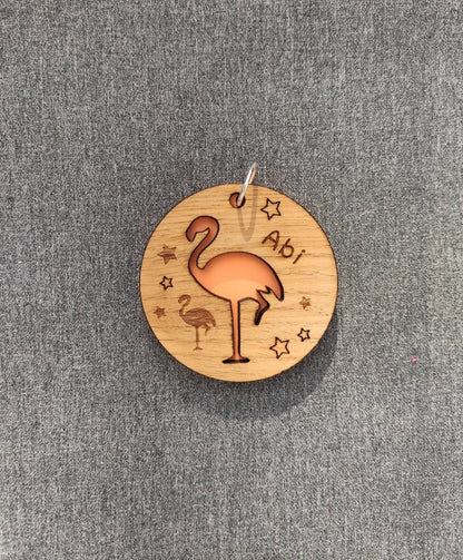 Round wooden keyring with colourful acrylic backing and a laser-cut Flamingo design – personalised with engraved child’s name, perfect for school bags.
