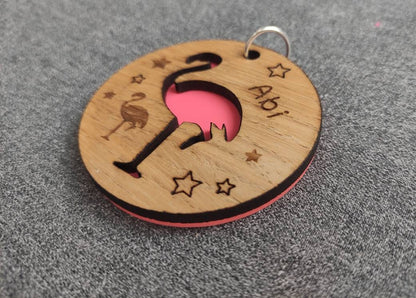 Round wooden keyring with colourful acrylic backing and a laser-cut Flamingo design – personalised with engraved child’s name, perfect for school bags.